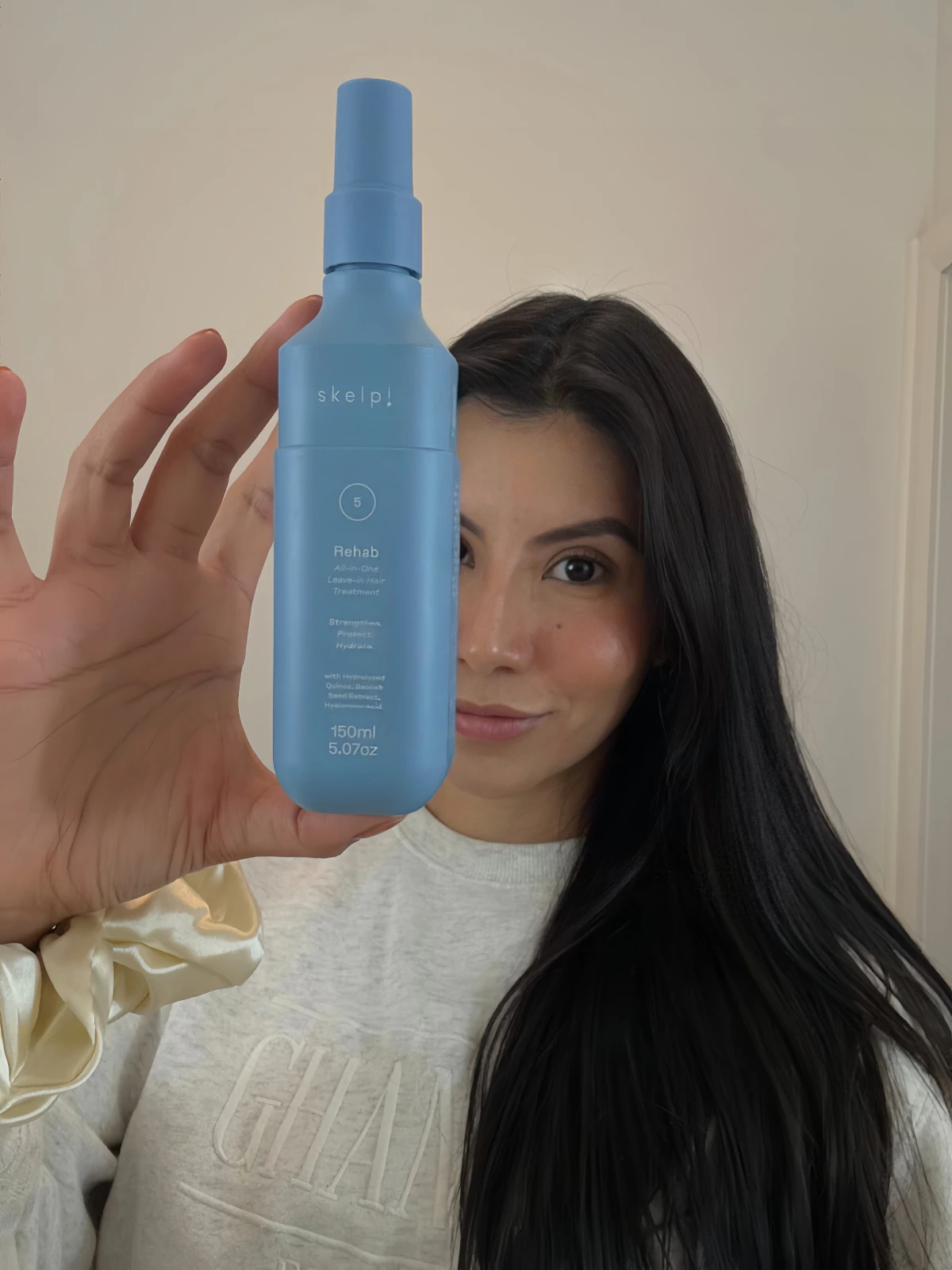 Millen Guerrero holding a skincare mist for UGC product content