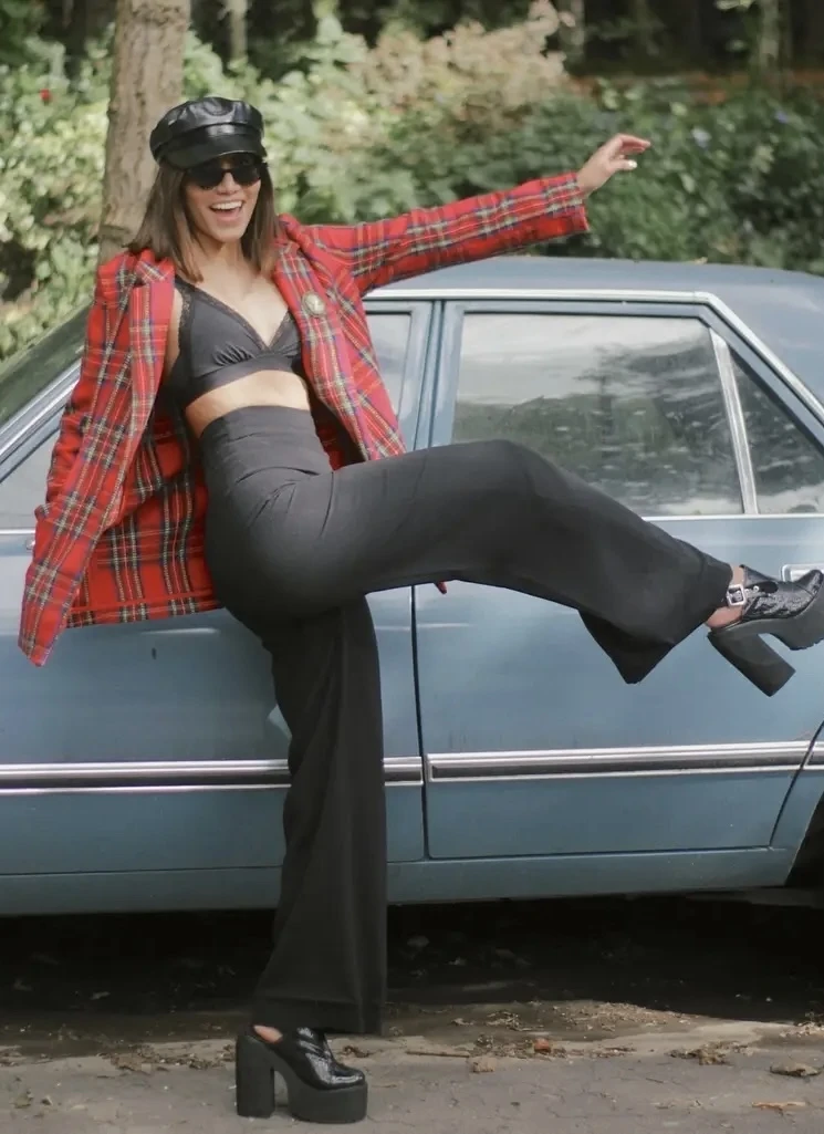 Millen Guerrero posing against a vintage car for a street fashion shoot