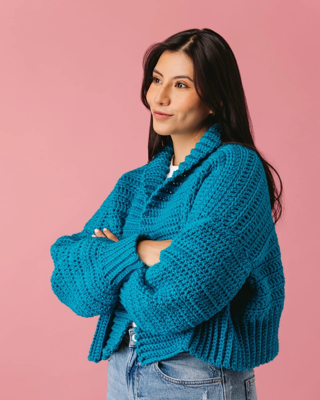Millen Guerrero in a knitted sweater on a soft studio backdrop