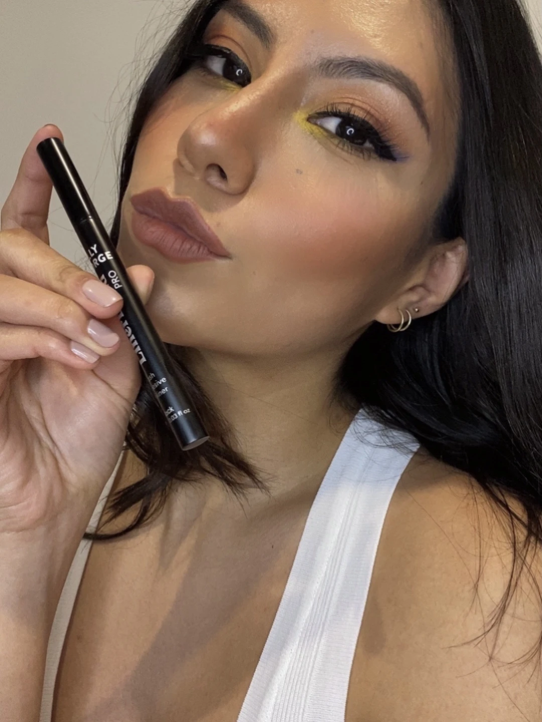 Beauty close-up of Millen Guerrero holding a lip product